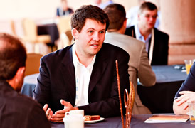 man listening to conference speakers